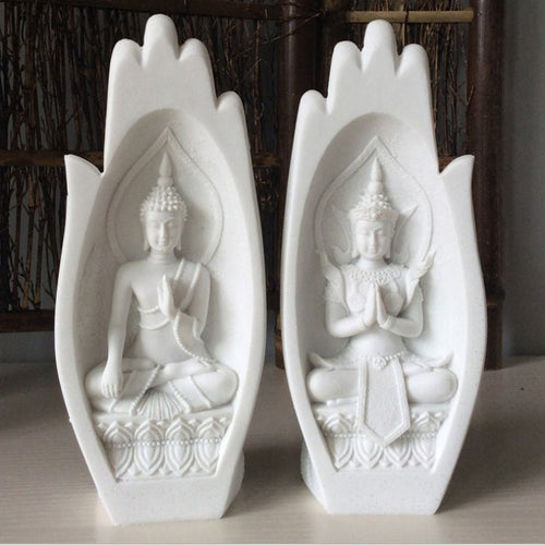 White Buddha statues in hand-shaped frames for modern home decor