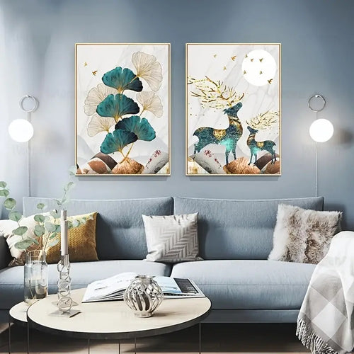 Modern living room with blue sofa, decorative pillows, and nature-themed wall art featuring ginkgo leaves and deer.