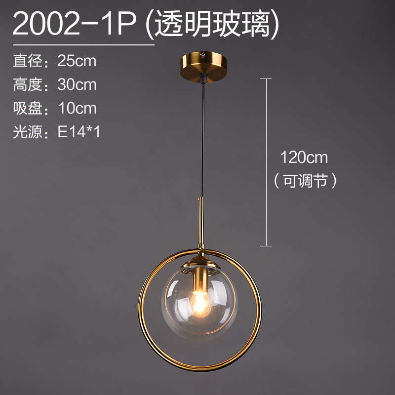Modern gold pendant light with clear glass globe, adjustable height for contemporary home decor