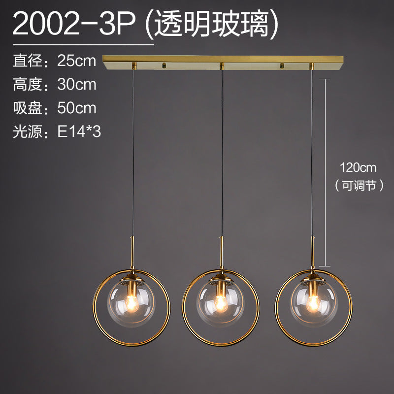 Modern gold pendant lights with clear glass shades, adjustable height for contemporary home decor