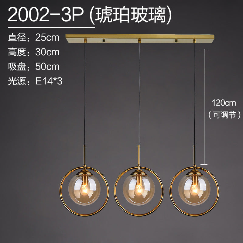 Modern 3-light pendant with amber glass globes, gold rings, adjustable 120cm cords, E14 bulbs